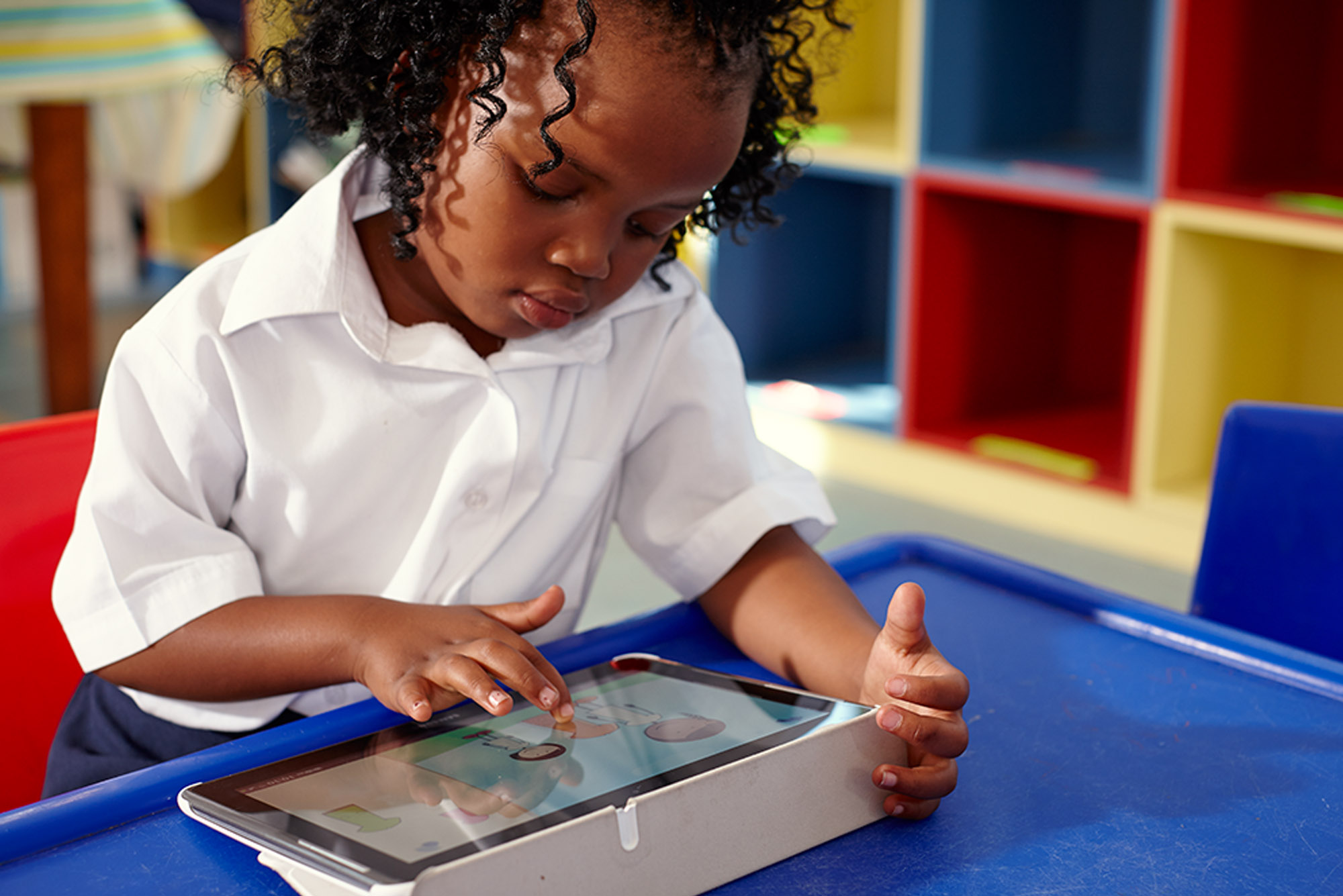 Young learner on tablet in classroom